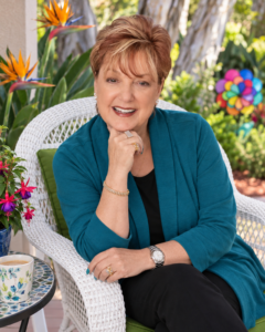 Susan Bock sitting on wicker chair in her garden